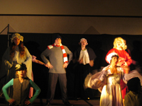 Six people in winter clothes singing